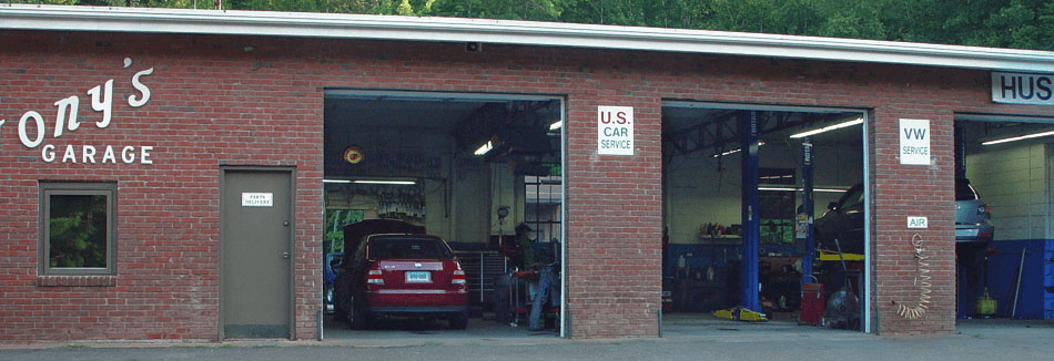 Three open service bays at Tony's Garage.